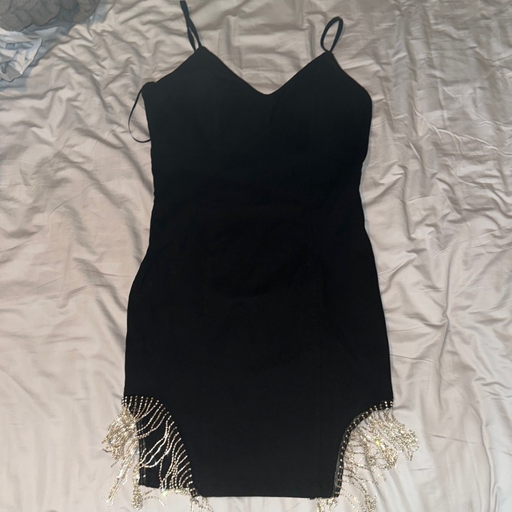 Black tight fit dress with sparkles on the end!